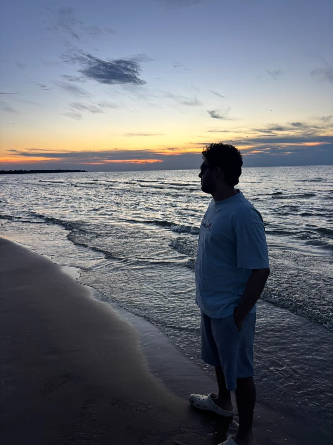 Mahad Farooq, founder of MCATCRUSH, on a beach at sunset